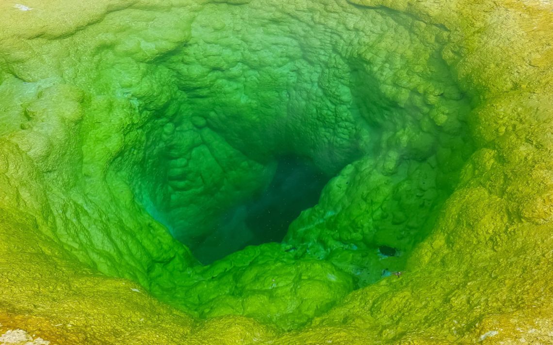 Close Up Of The Vivid Green Water Of Morning Glory Pool In Yello